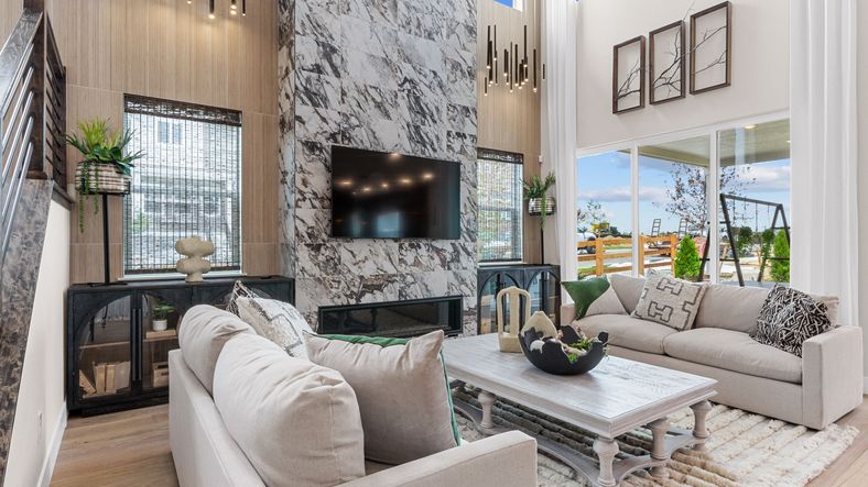 Experience Dillon Pointe's grandeur with a stunning marble fireplace, soaring ceilings, and expansive windows.