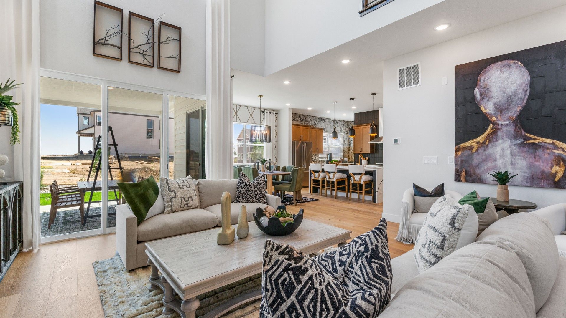 Luxurious open-plan space with soaring ceilings, elegant finishes, and expansive windows in Dillon Pointe.