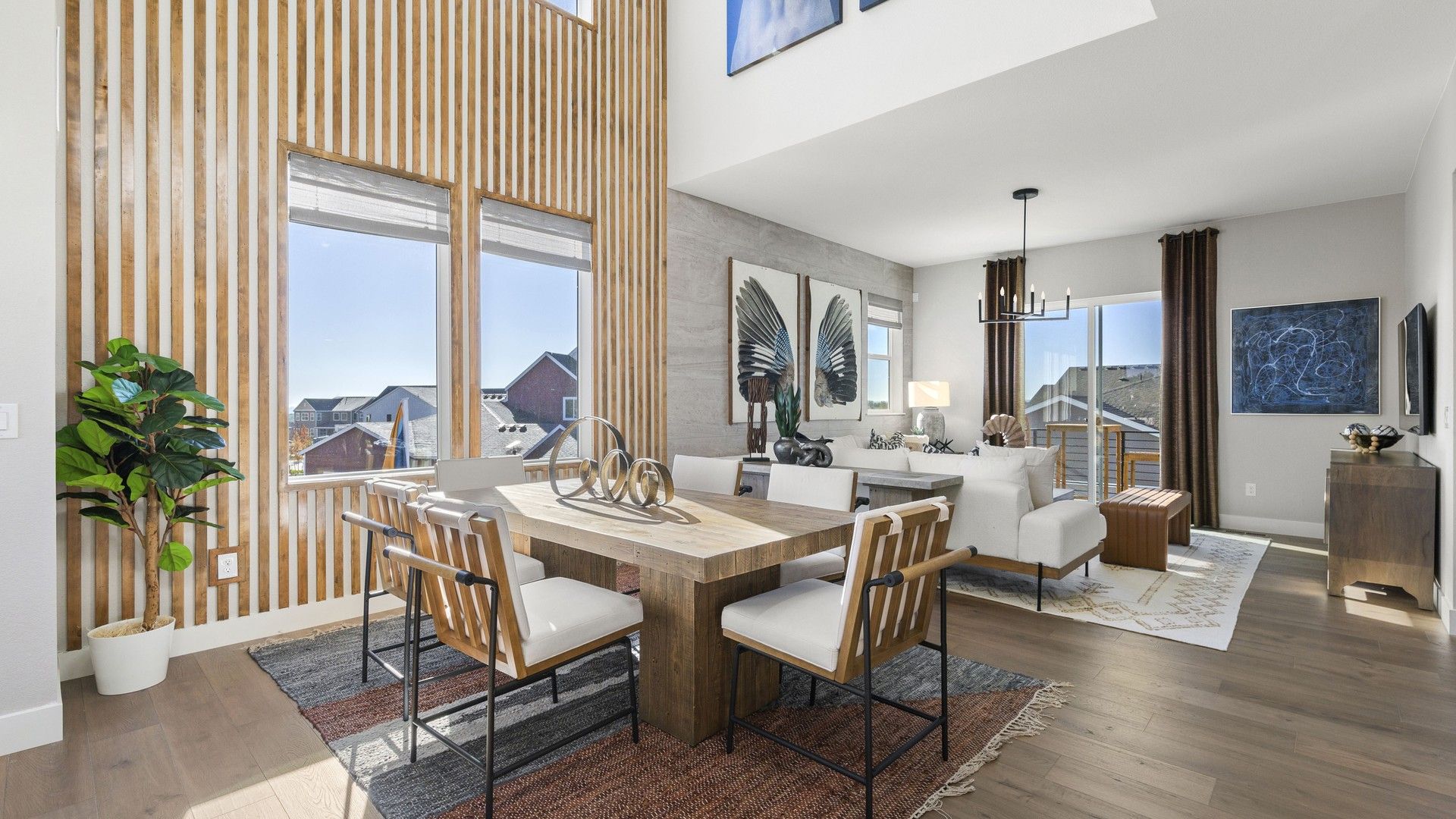 Luxurious wooden slat walls complement expansive windows and chic decor in Dillon Pointe's elegant living space.