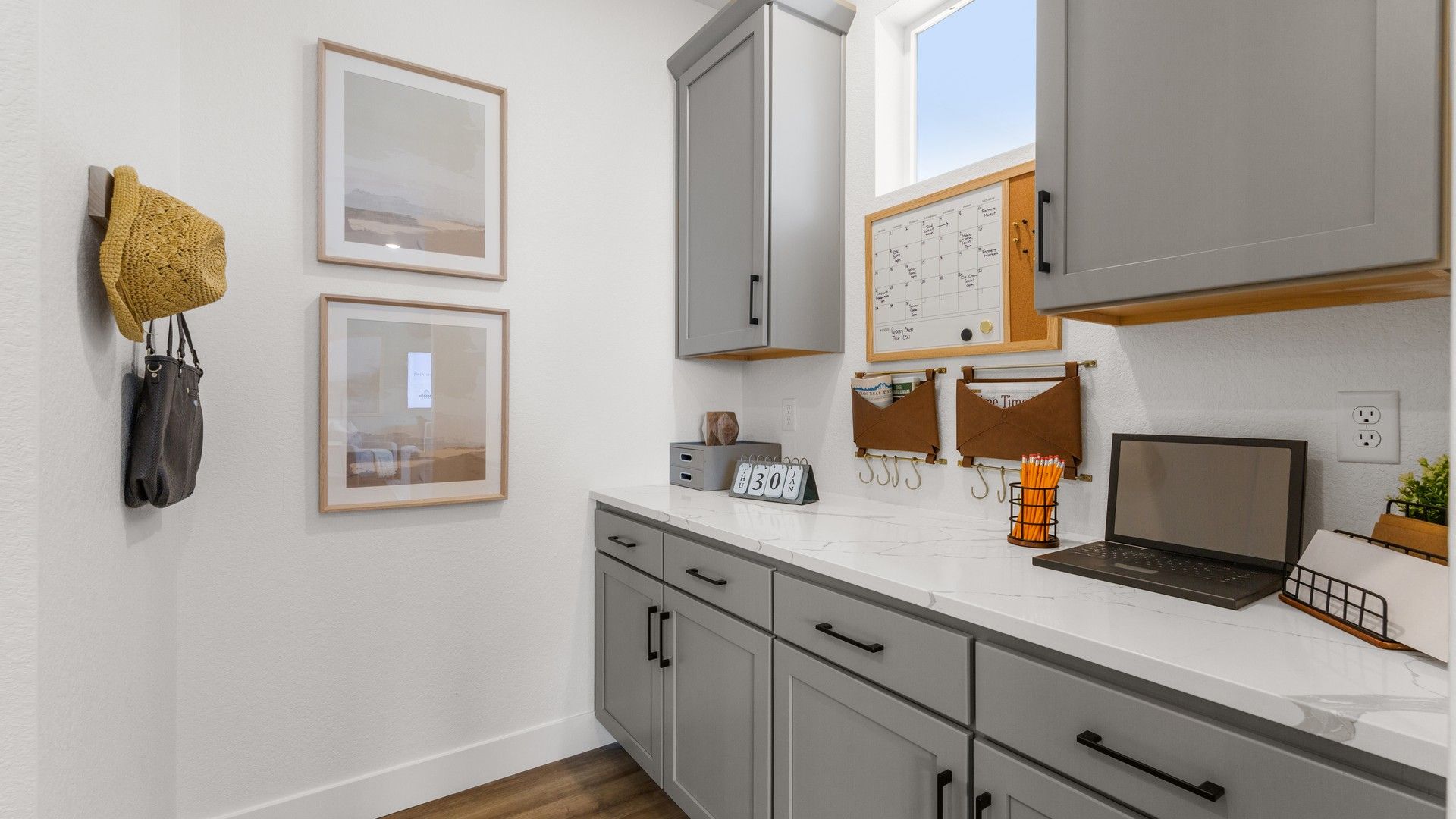 Elegant cabinetry and sleek quartz countertops elevate this luminous home office in Bloom community.