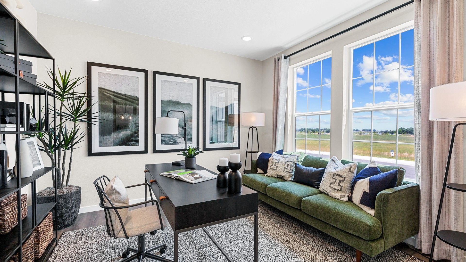 Timnath Lakes offers a chic office with expansive windows and plush green seating, merging elegance and functionality.