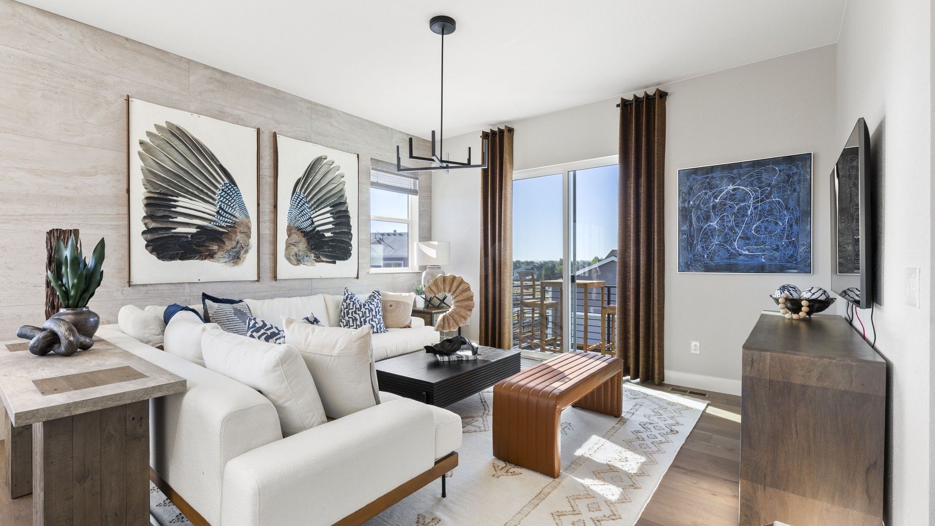 Sophisticated living room featuring floor-to-ceiling windows and chic modern art in Dillon Pointe.