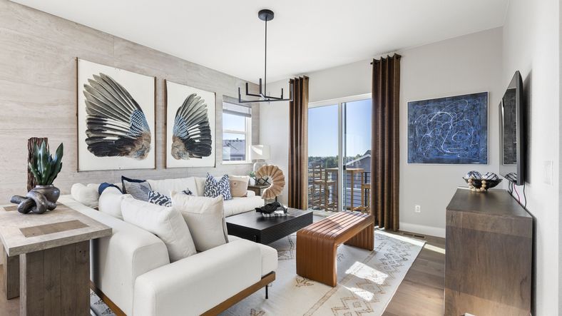 Sophisticated living room featuring floor-to-ceiling windows and chic modern art in Dillon Pointe.