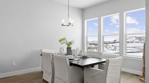 Savor serene dining with expansive mountain vistas through oversized windows in Montaine's luxurious setting.
