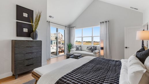 Elegant bedroom with vaulted ceiling, refined furnishings, expansive views, Dillon Pointe.