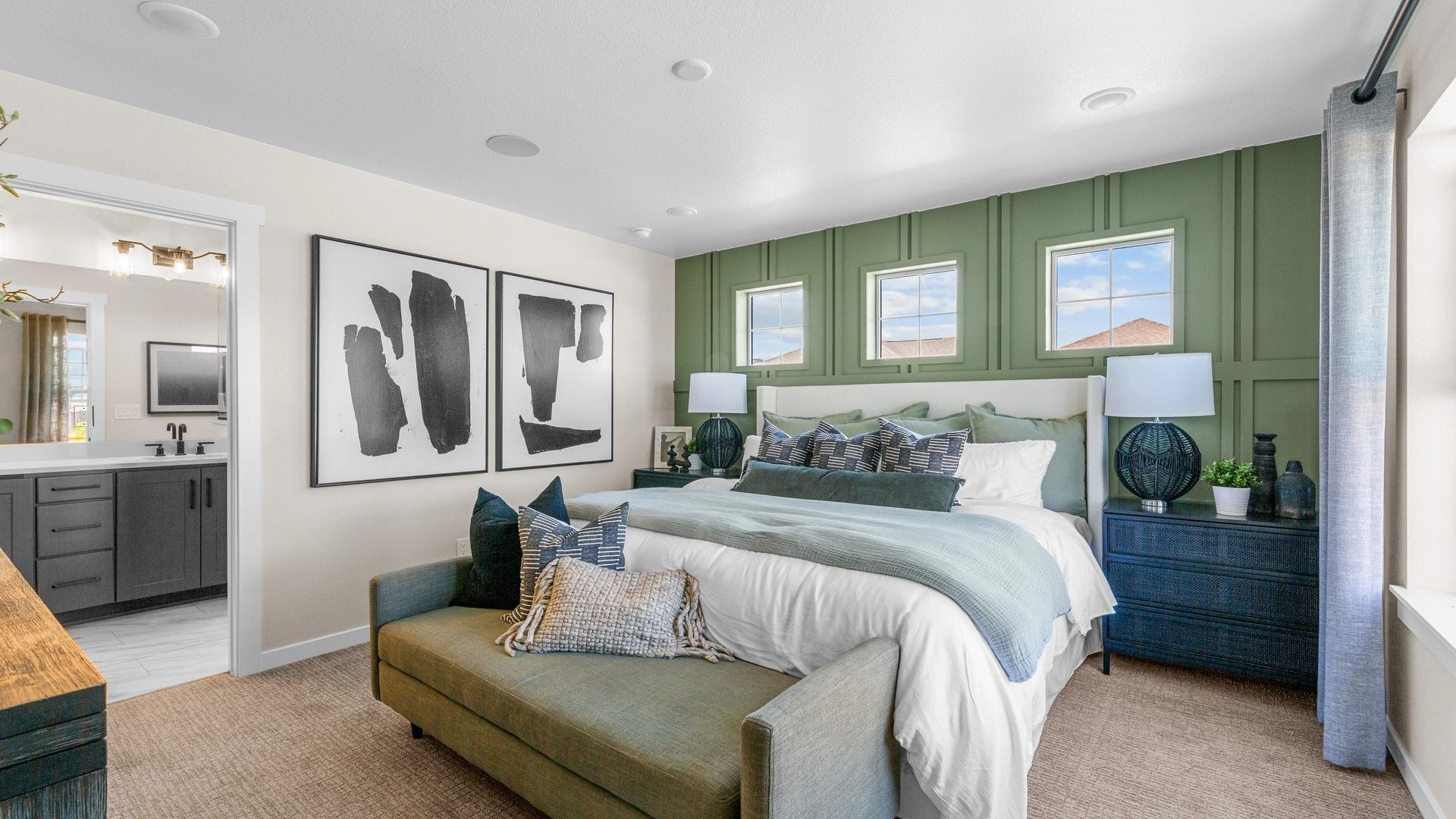 Luxurious Timnath Lakes bedroom features bespoke green accent wall and plush furnishings.