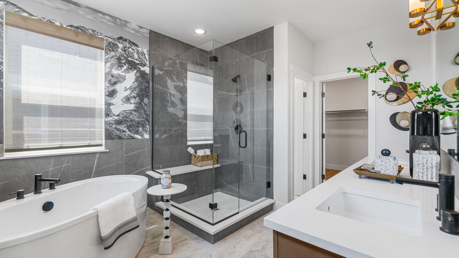 Experience refined elegance with a freestanding tub and an artistic mountain mural in Dillon Pointe's exclusive bath.