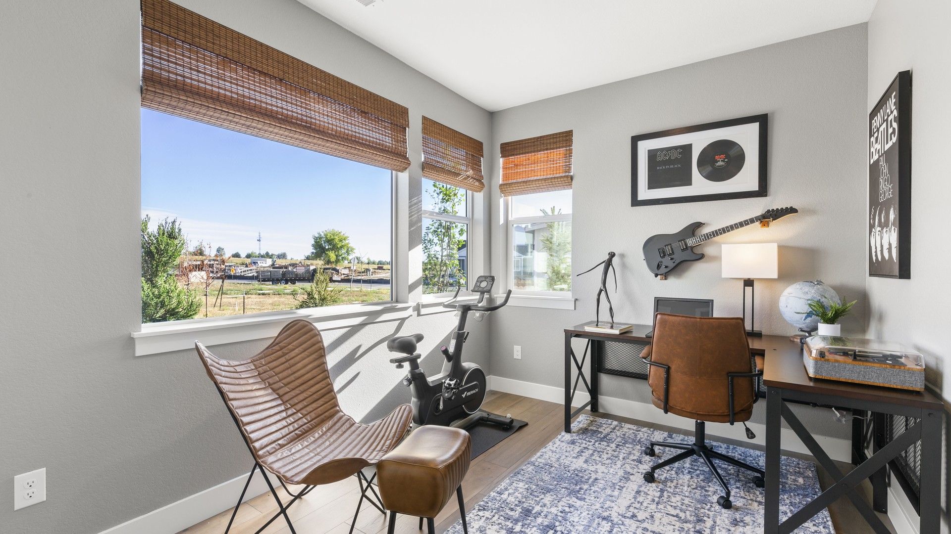 Elegant Dillon Pointe office features chic leather seating and guitar decor with expansive view.