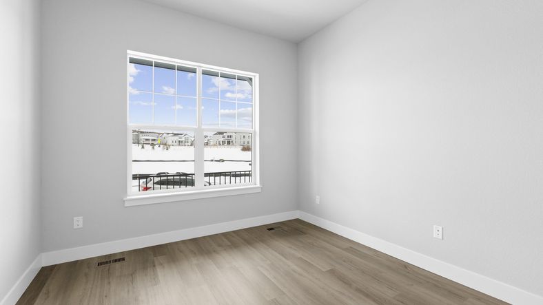 Elegant hardwood floors and expansive window offer breathtaking views of Montaine, Castle Rock.