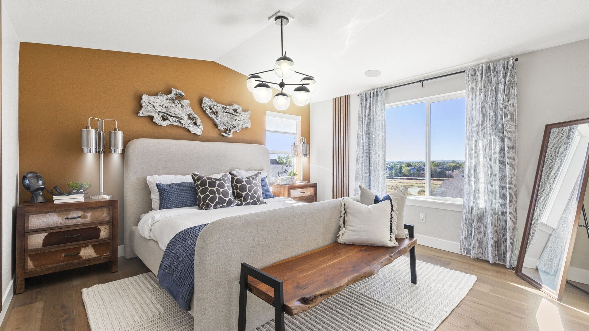 Elegant master bedroom features chic wood accents and panoramic views in Dillon Pointe.