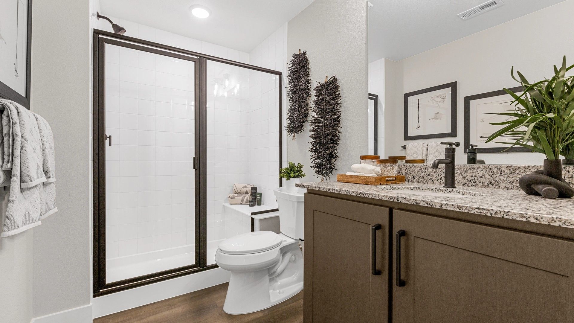 Experience luxury with granite countertops, elegant fixtures, and pristine glass shower in Timnath Lakes.