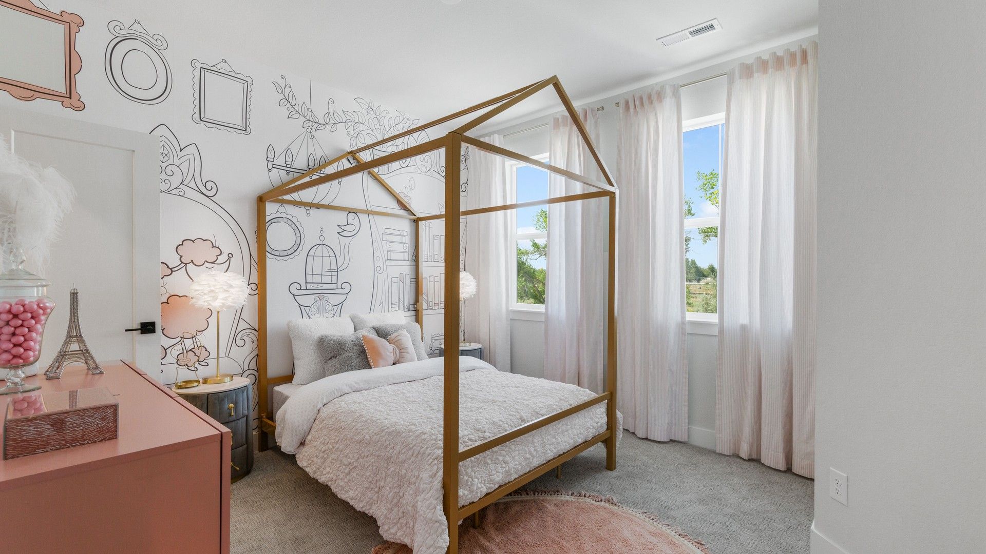Elegant canopy bed accents the bedroom's artistic walls and airy windows in Dillon Pointe.