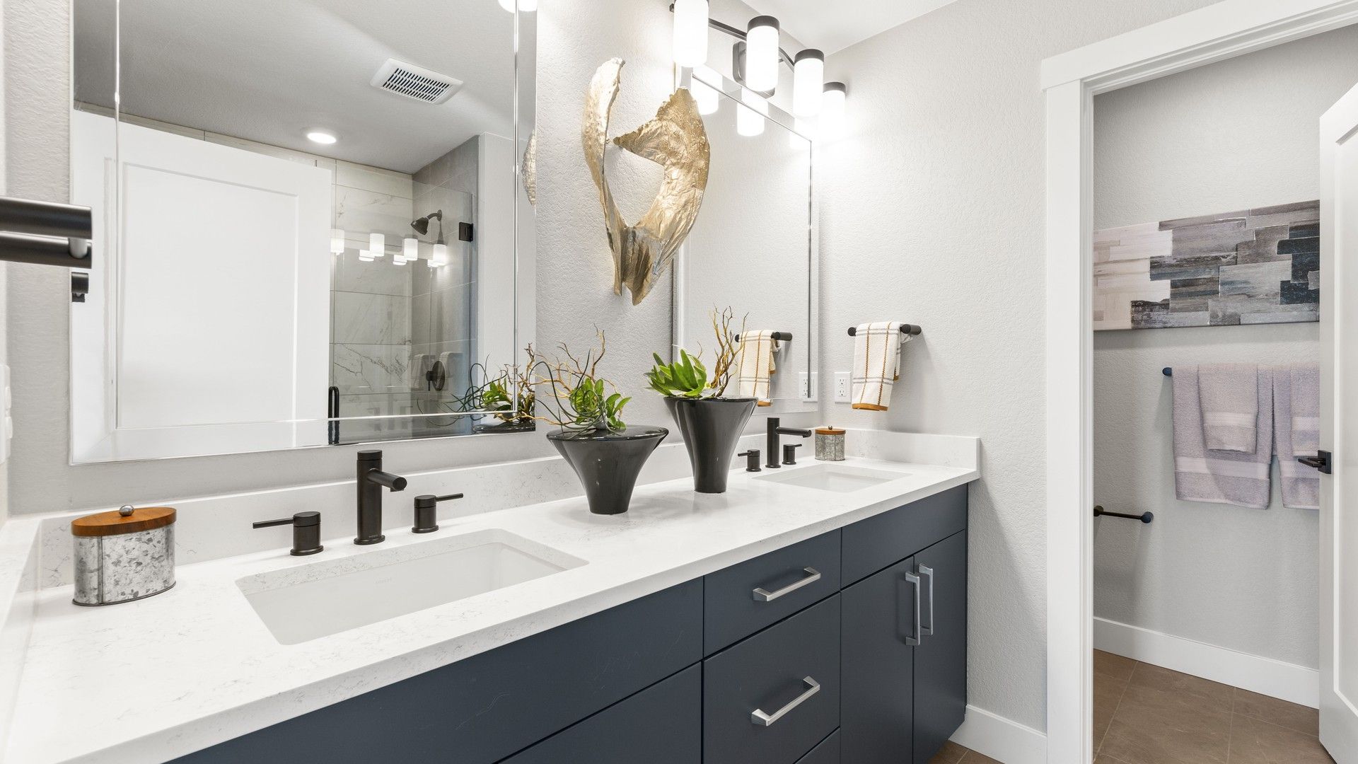 Luxurious Dillon Pointe bathroom featuring dual sinks, marble countertop, and sophisticated lighting.