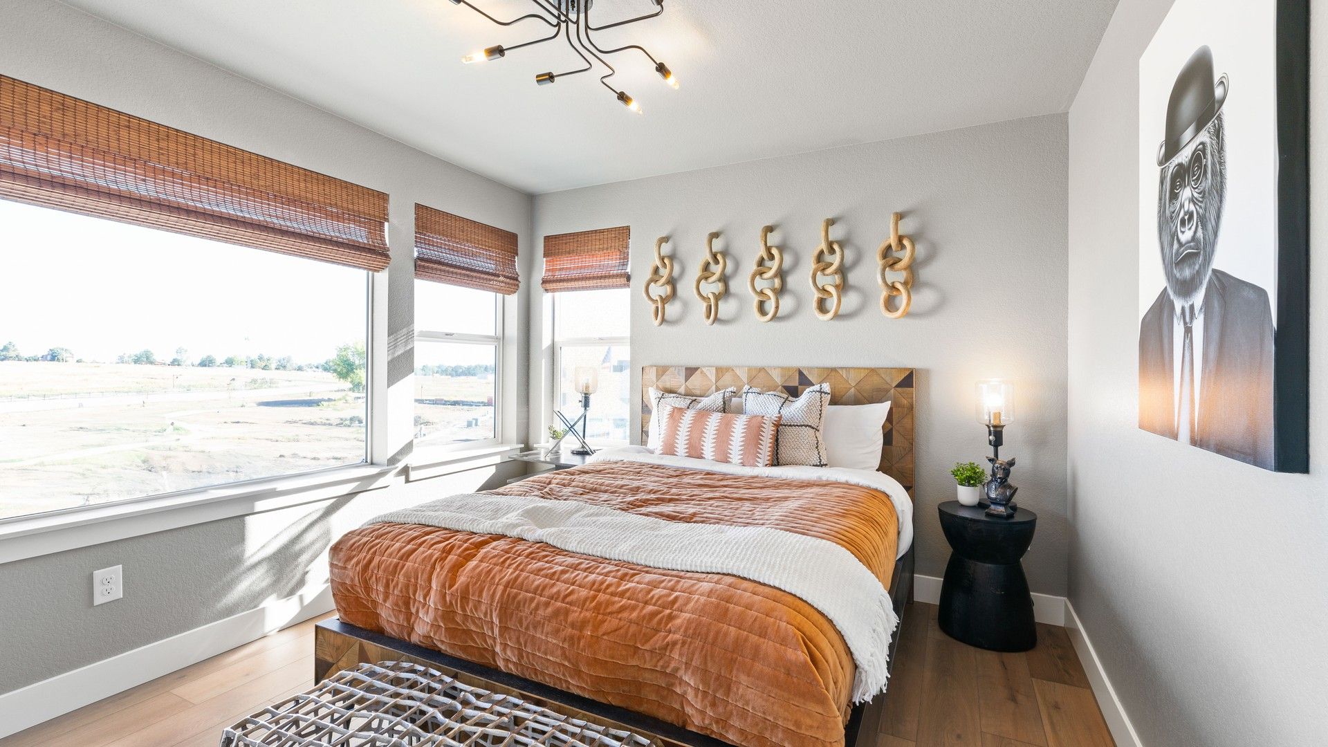 Experience luxury with soft lighting, elegant woodwork, and expansive views in Dillon Pointe's modern bedroom.