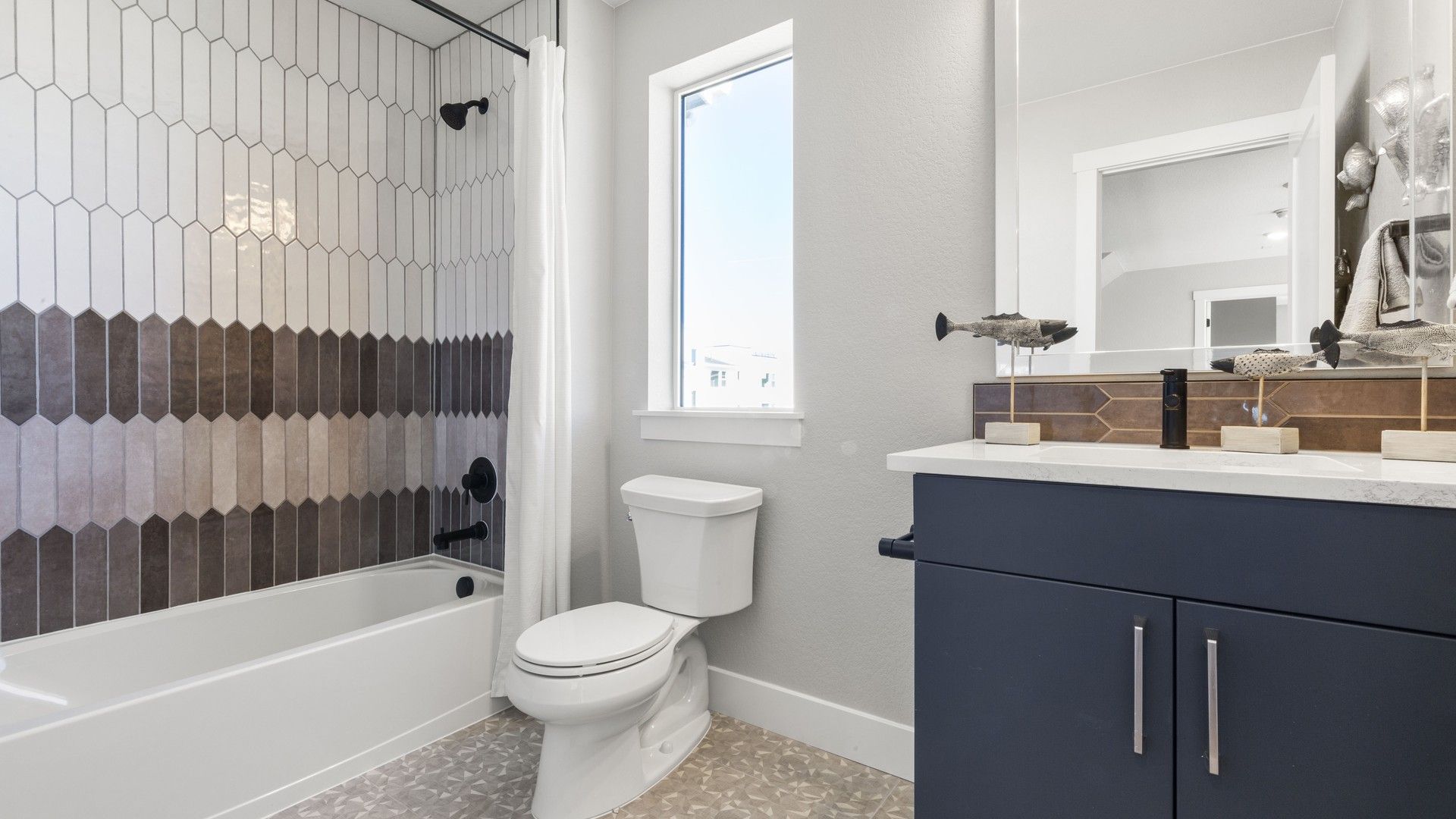 Luxurious bathroom showcasing intricate wall tiles and modern fixtures in Dillon Pointe.