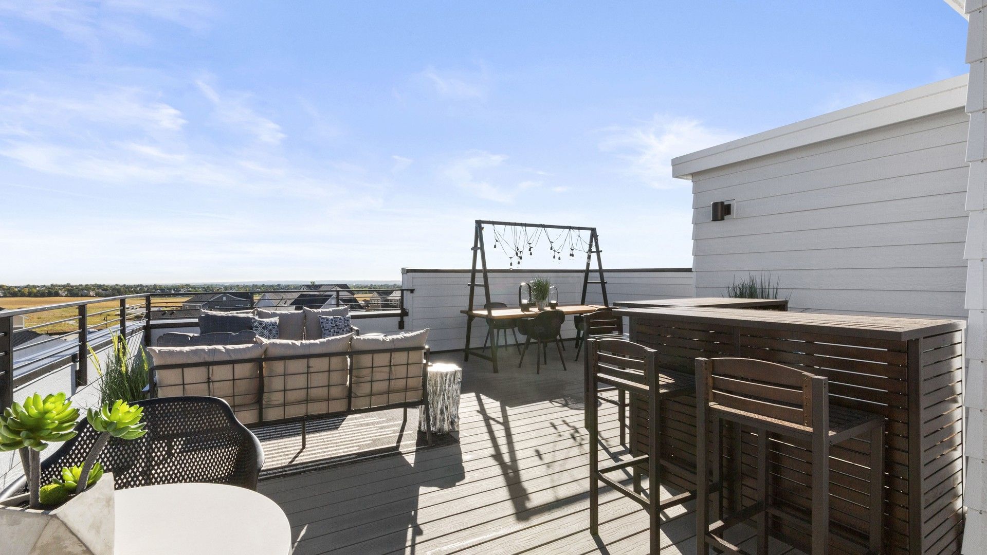 Experience elegance on Dillon Pointe's rooftop with premium wood finishes, chic furniture, and stunning scenic views.