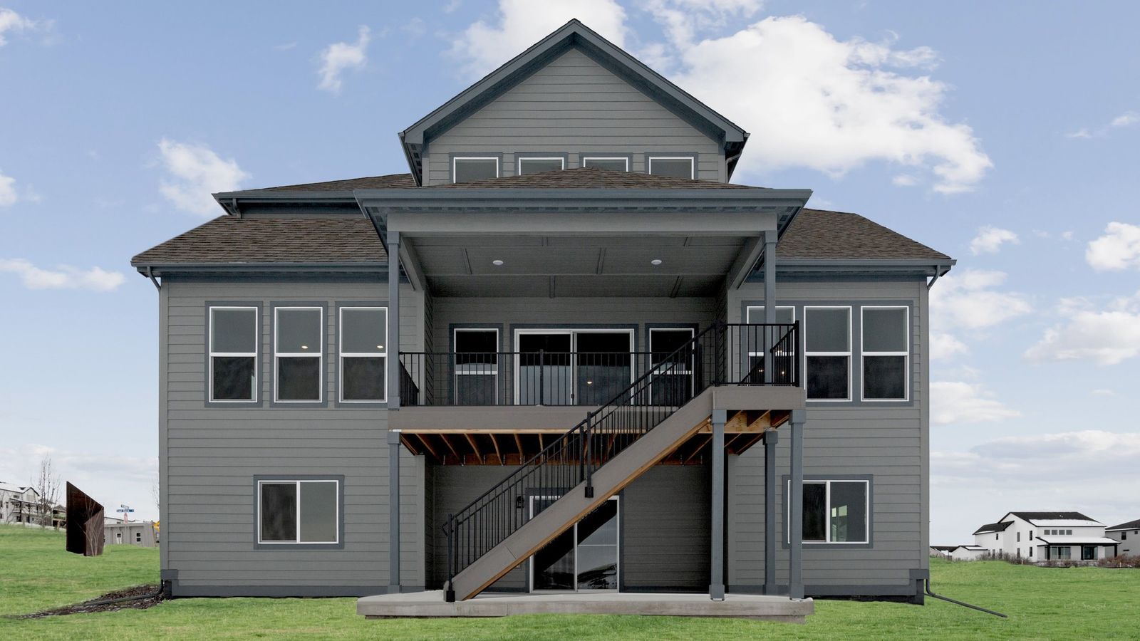 Experience luxury in Montaine with this elegant home featuring a central stairway and spacious open porch.