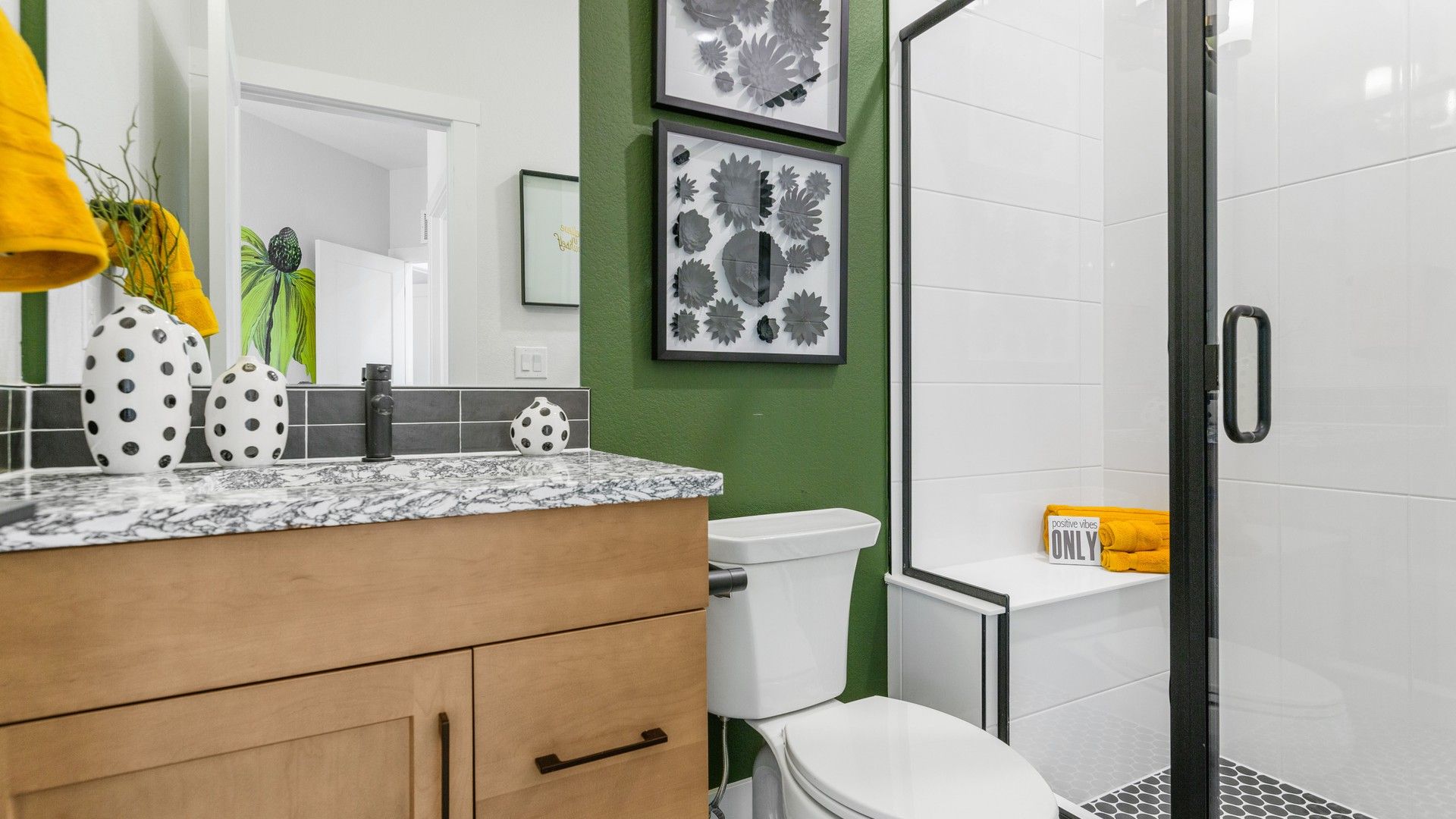 Elegant marble counter and bold polka dot decor accentuate this Dillon Pointe bathroom.