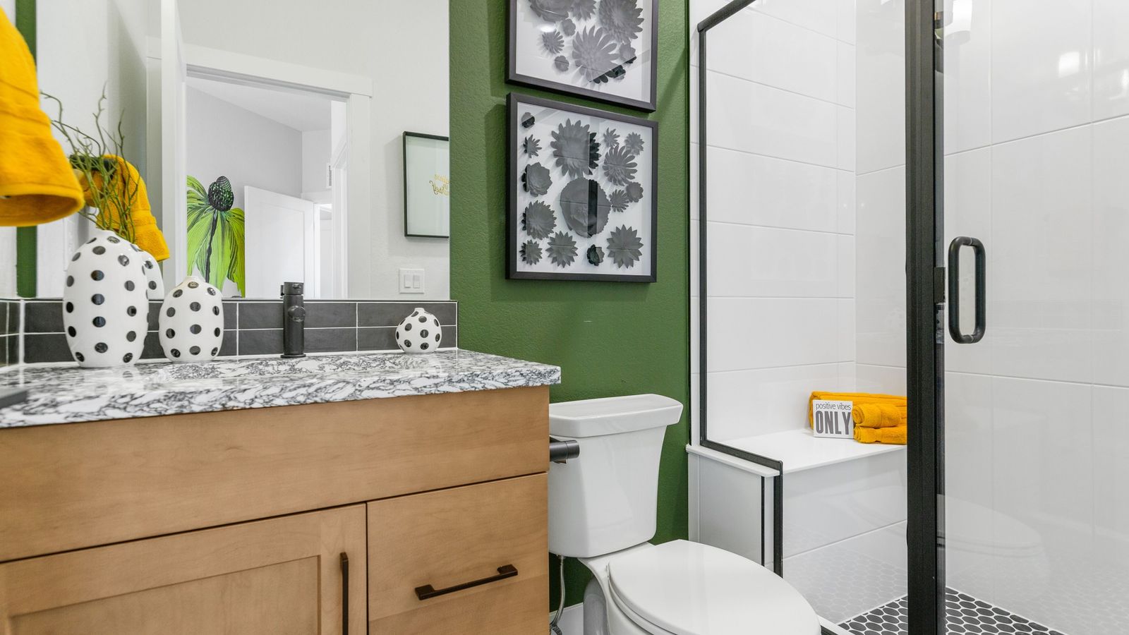Elegant marble counter and bold polka dot decor accentuate this Dillon Pointe bathroom.