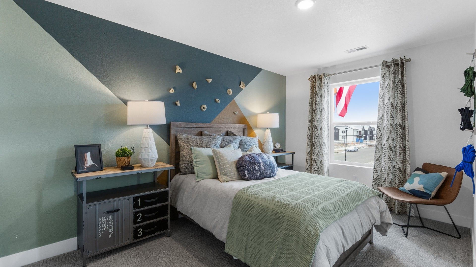 Luxurious bedroom features a striking geometric accent wall and chic decor in Bloom.