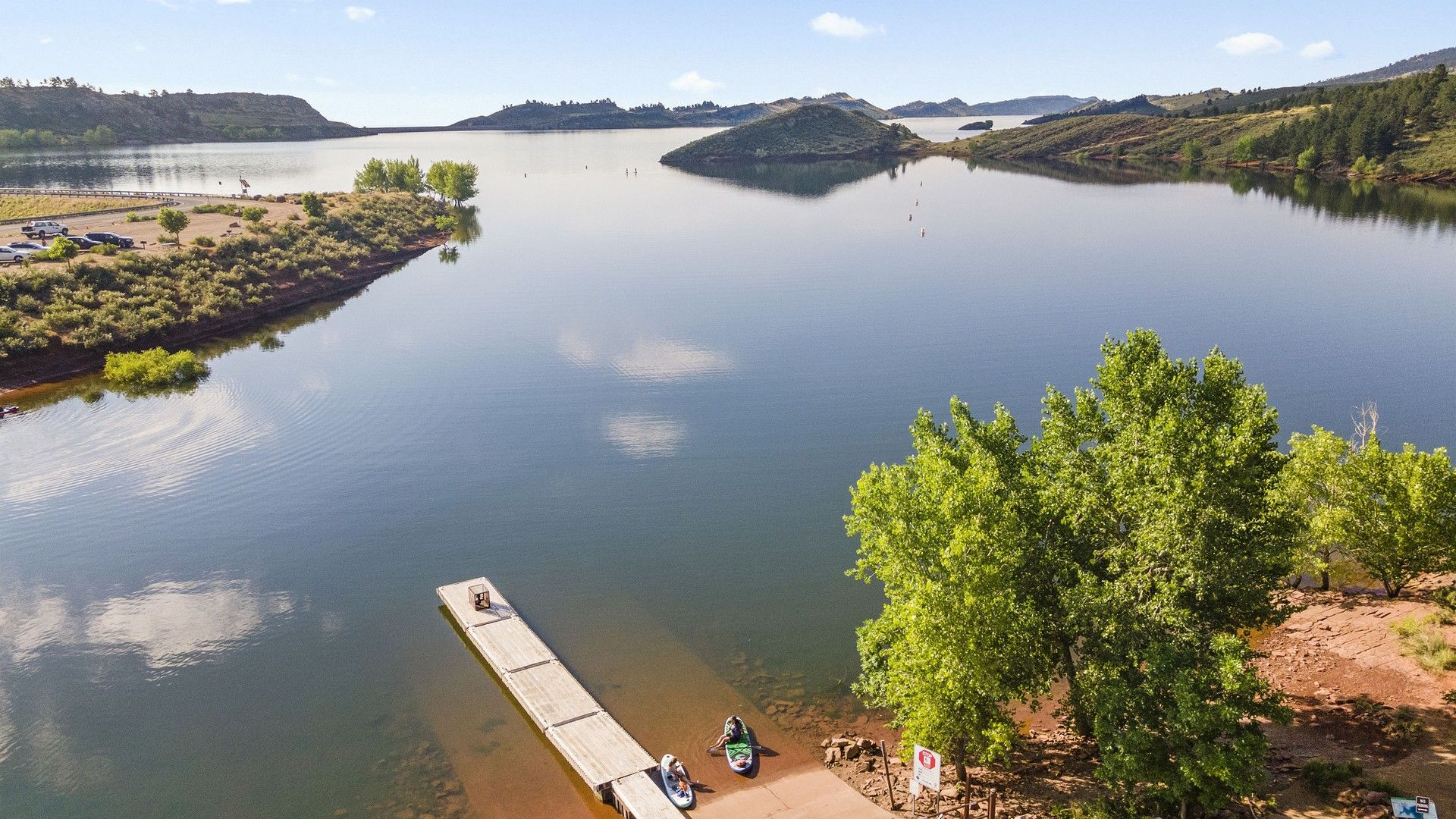 Experience tranquil waters and lush greenery from this elegant dock near Fort Collins.