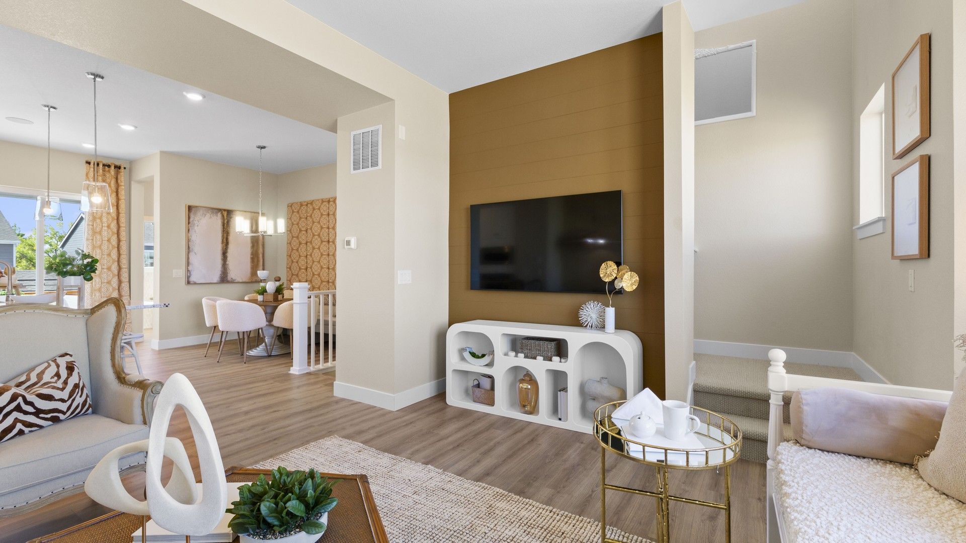 Discover refined elegance in Dillon Pointe with sleek wood floors and a chic brown accent wall.