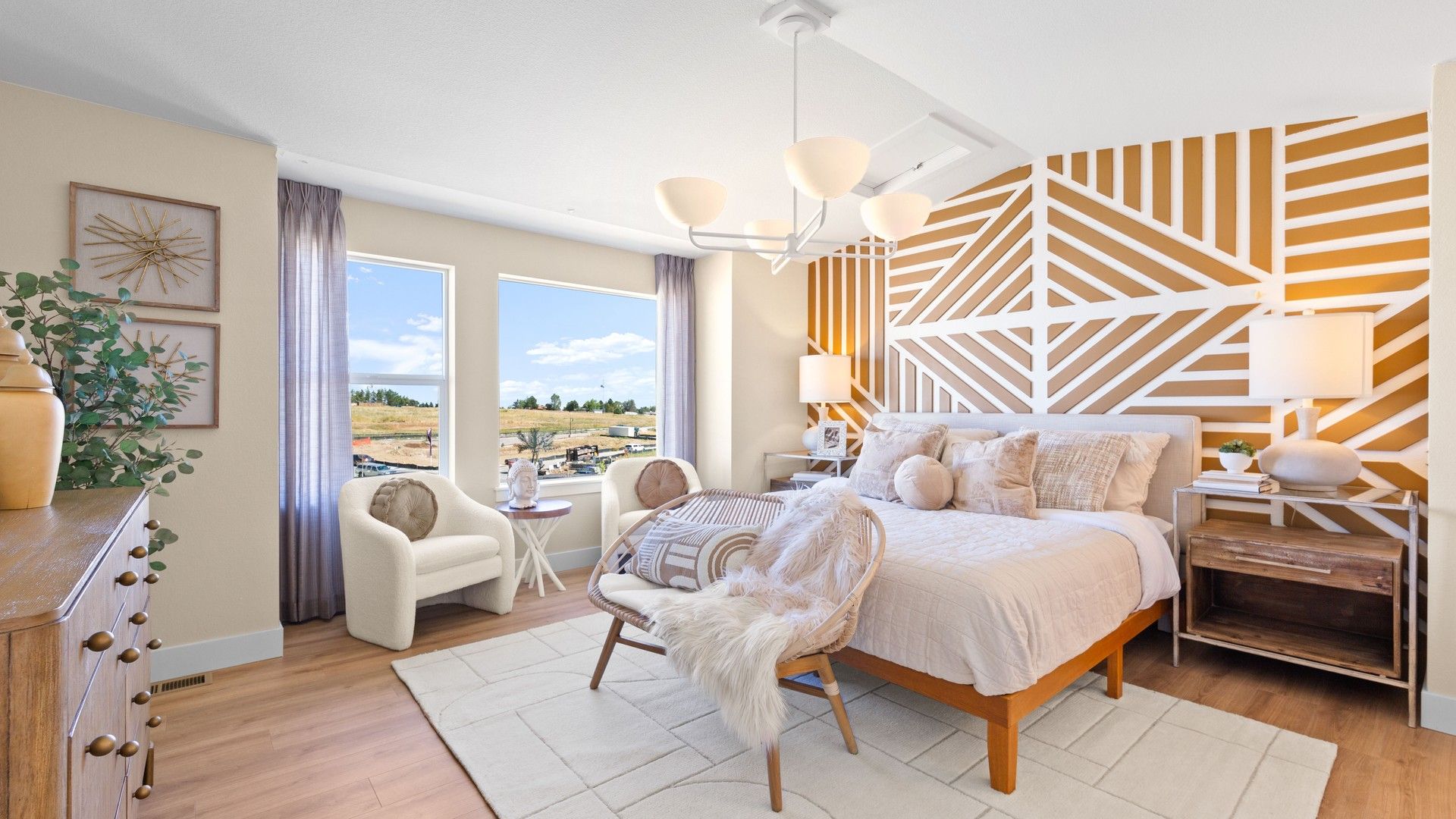 Dillon Pointe bedroom boasts a striking geometric accent wall and expansive windows for serene countryside views.