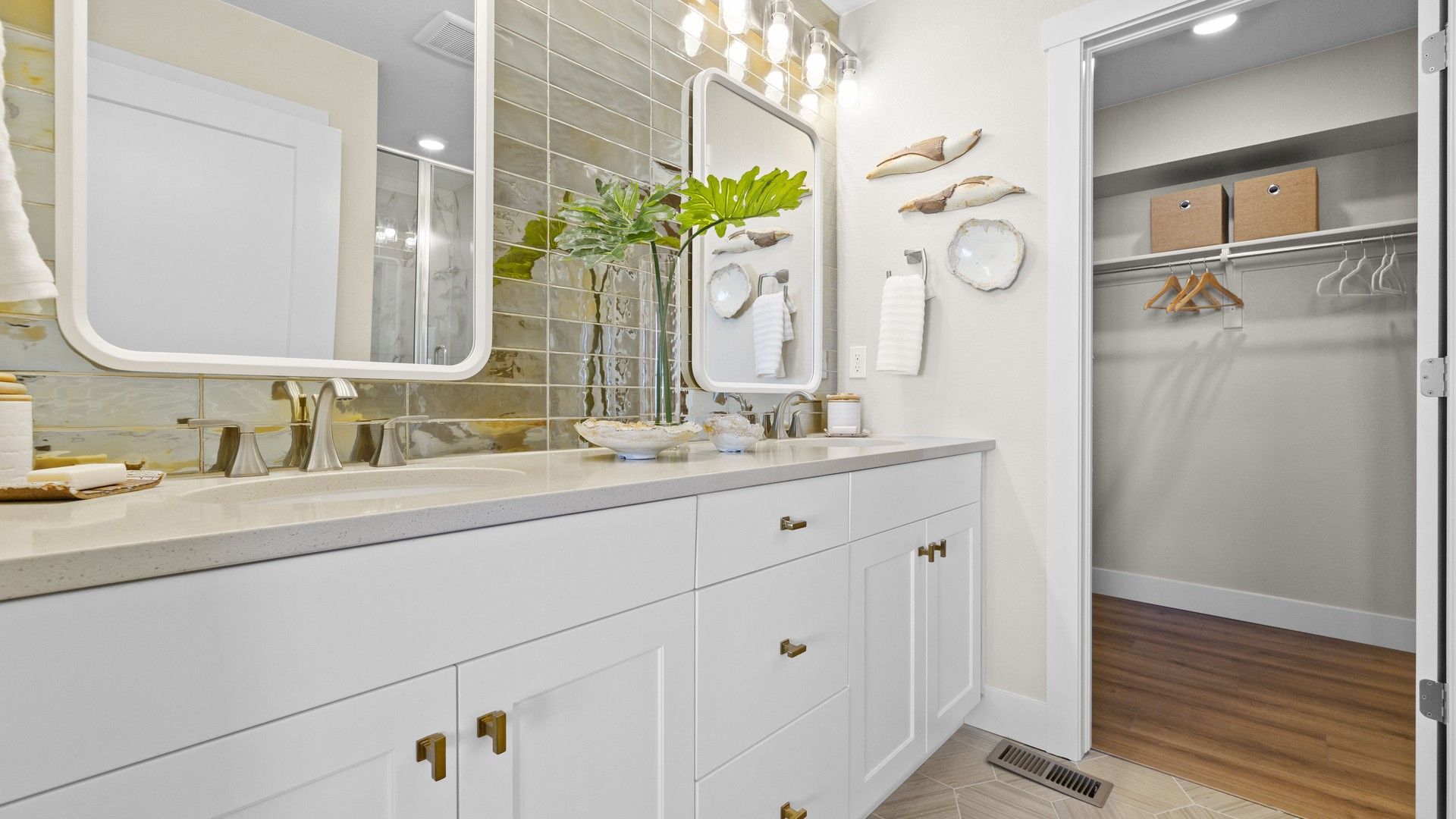 Step into luxury with Dillon Pointe's bathroom, featuring designer tile wall and refined fixtures.