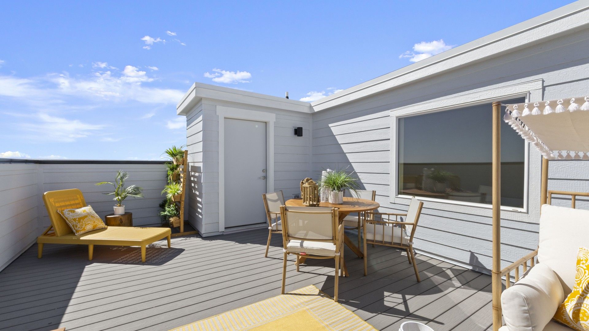 Experience luxury on the spacious rooftop deck featuring elegant wood textures in Dillon Pointe community.