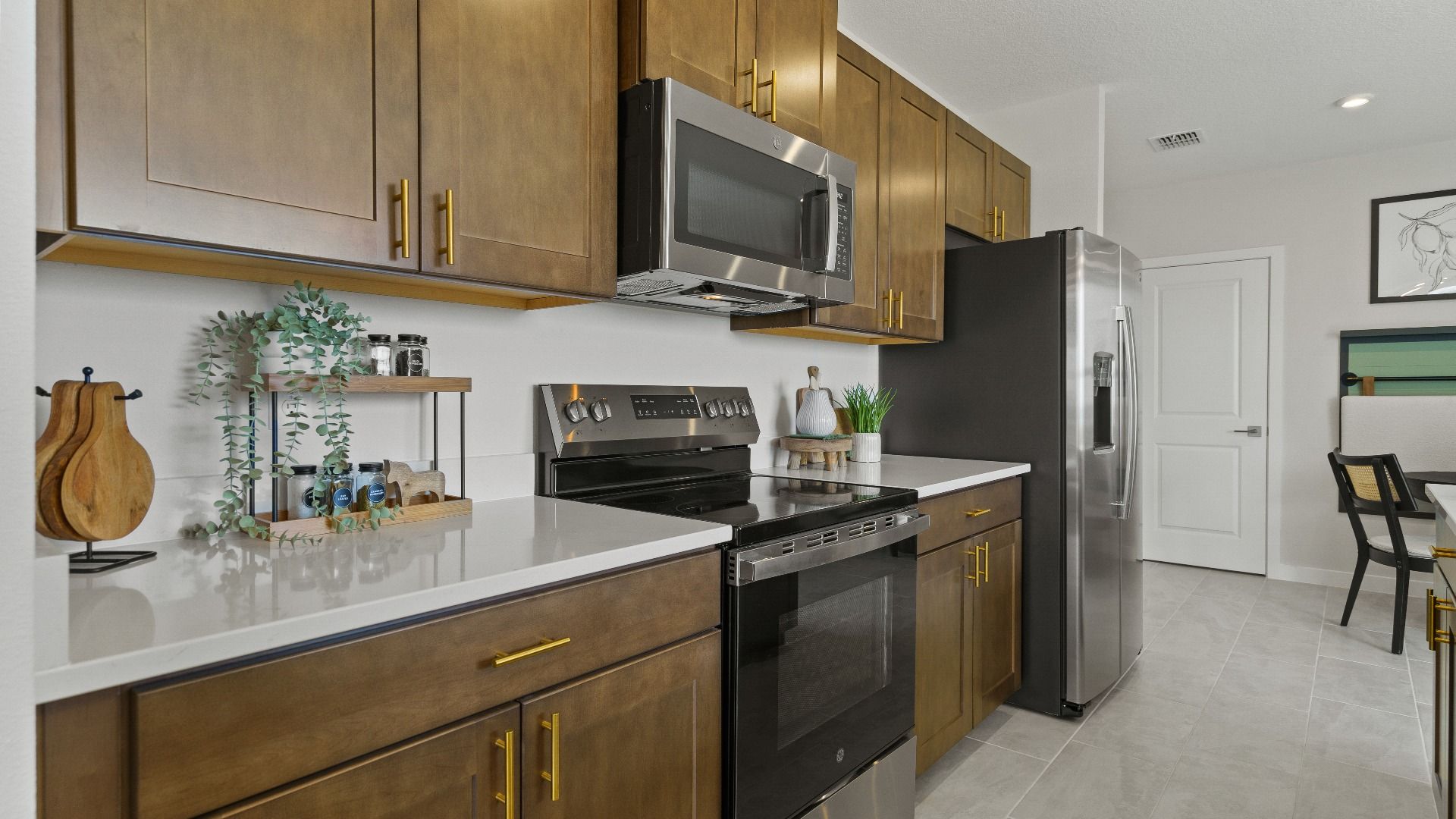 The Atlantic Model by DRB Homes Kitchen features dark wood cabinets and premium finishes.