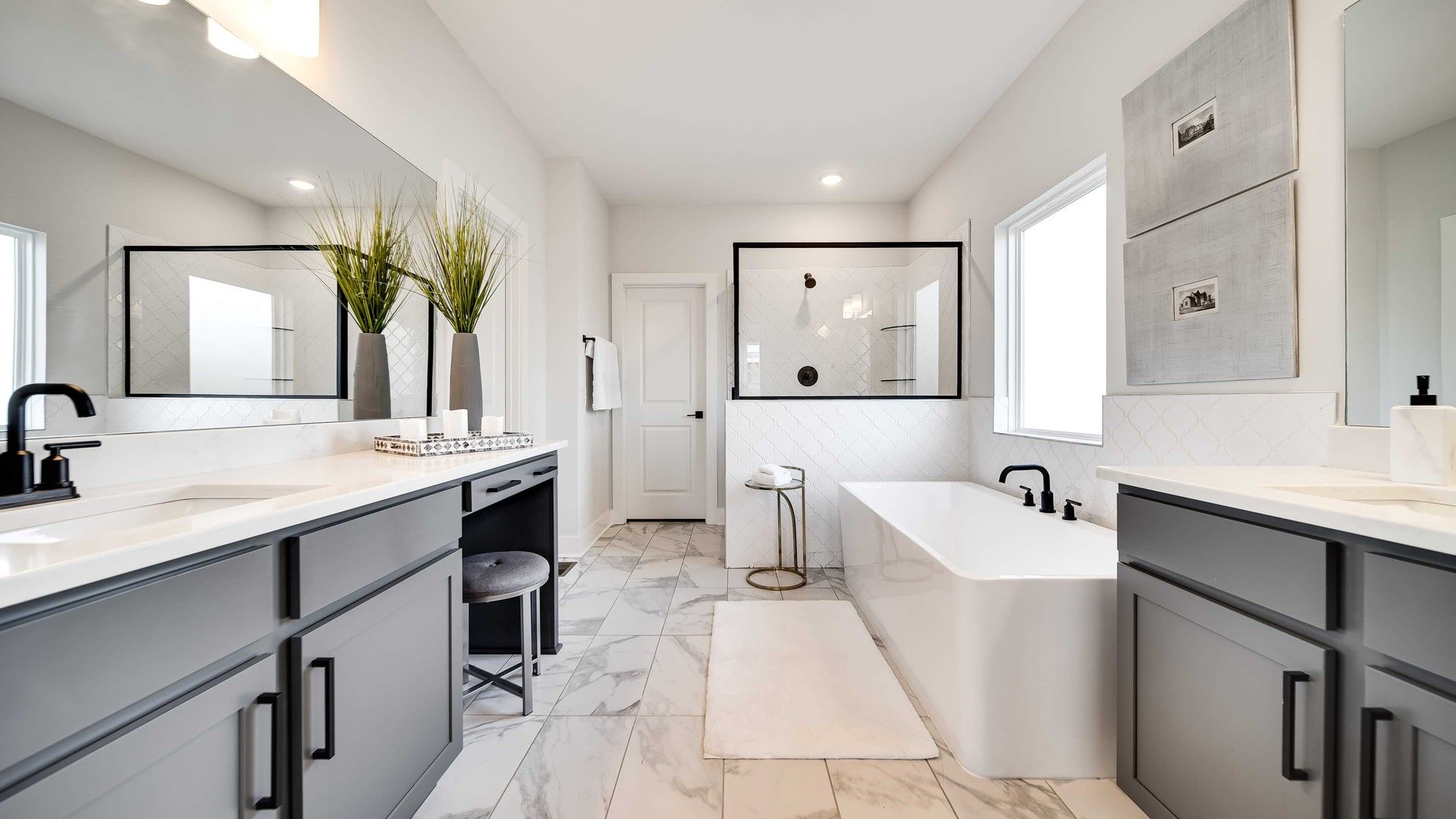 Indulge in elegance with marble flooring and sleek gray cabinetry in Brush Creeks' exquisite bathroom.