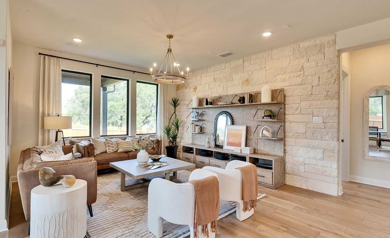 This San Gabriel living room boasts a stunning stone accent wall and expansive windows for a sophisticated ambiance.