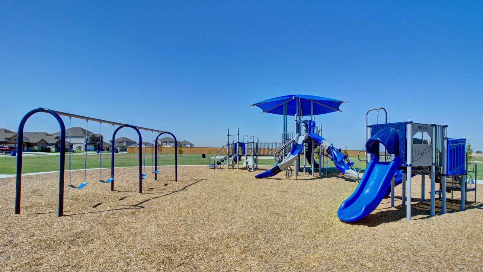 Discover modern outdoor play structures with vibrant slides in Dauer Ranch, surrounded by serene suburban settings.