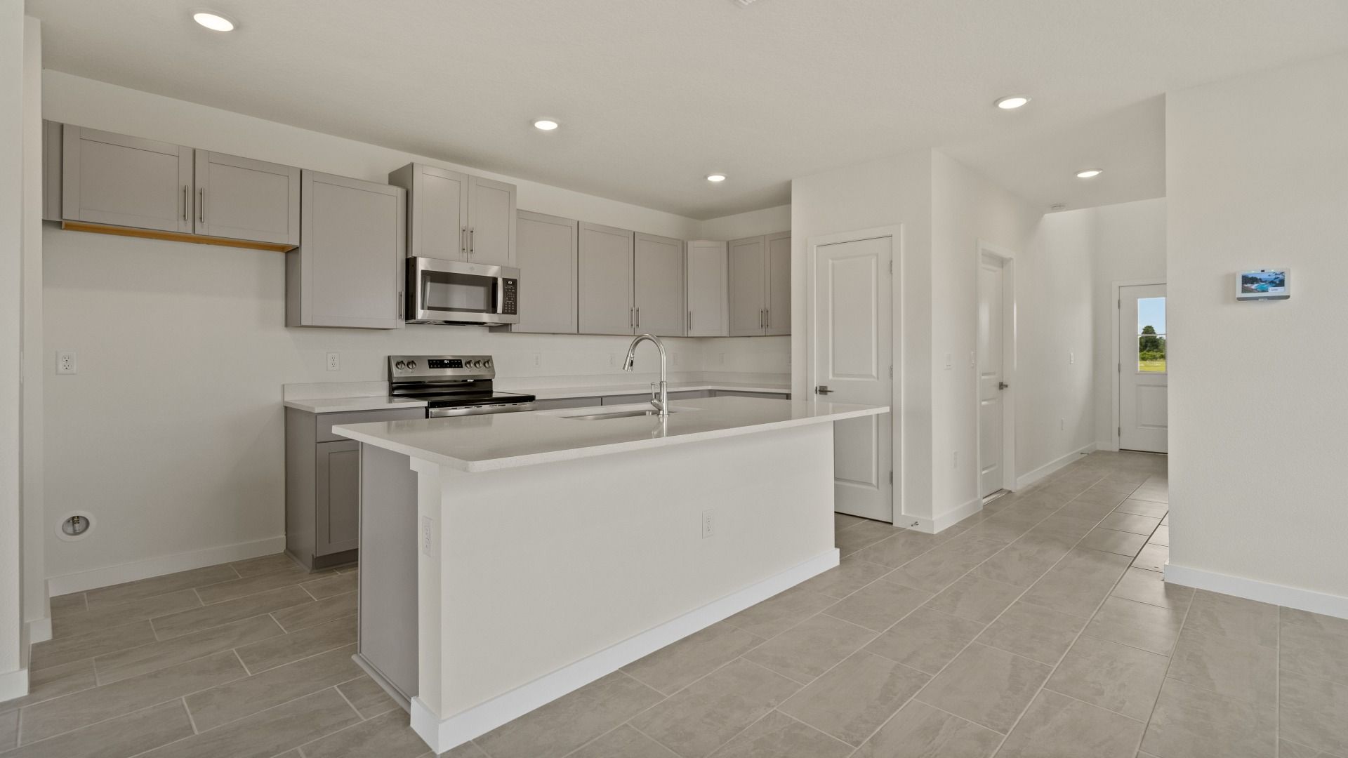 The Naples Kitchen with large Island Quick Move-In Home at Willowbrook North by DRB Homes in Winter Haven, FL