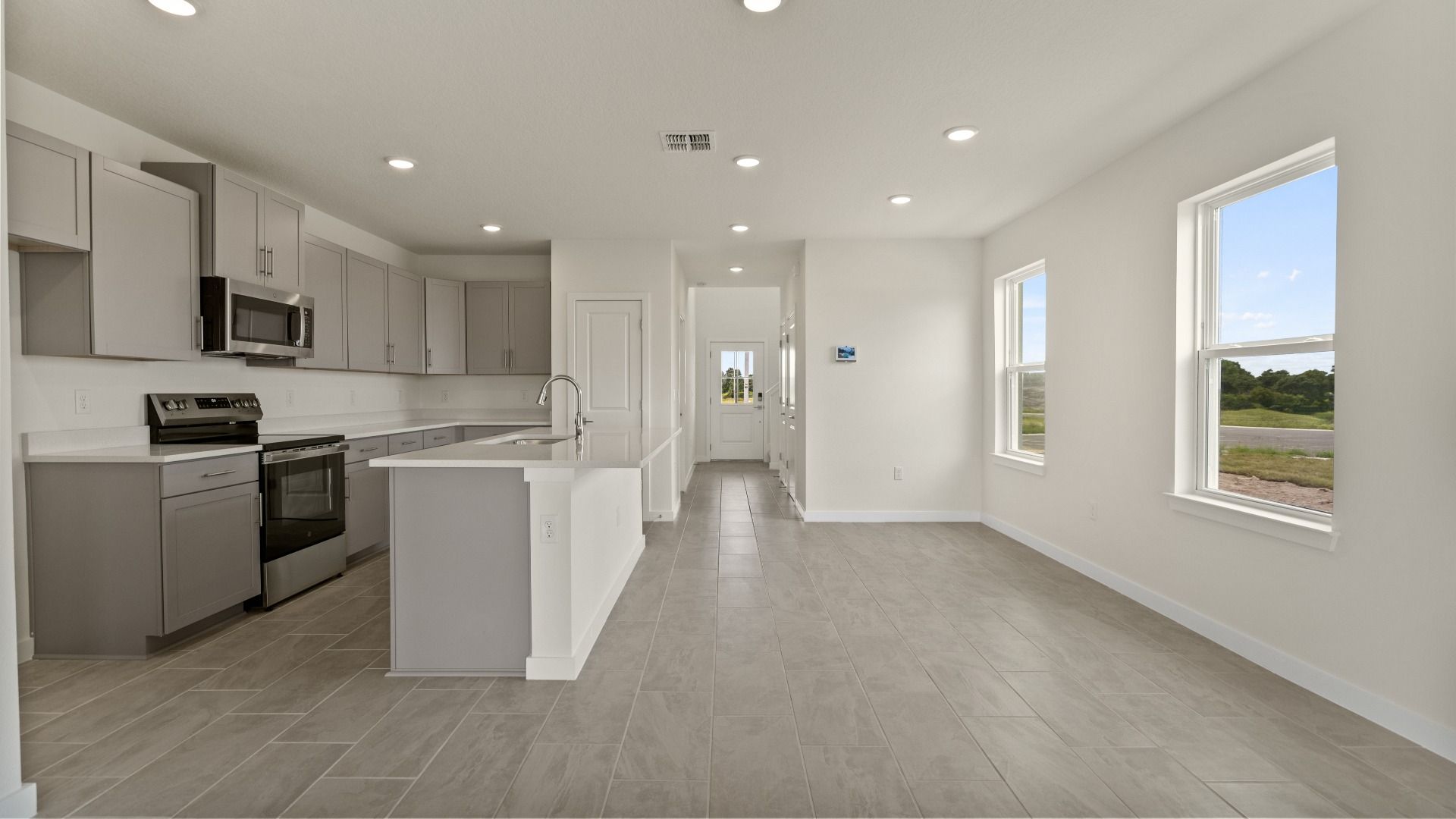 The Naples Kitchen with large Island Quick Move-In Home at Willowbrook North by DRB Homes in Winter Haven, FL