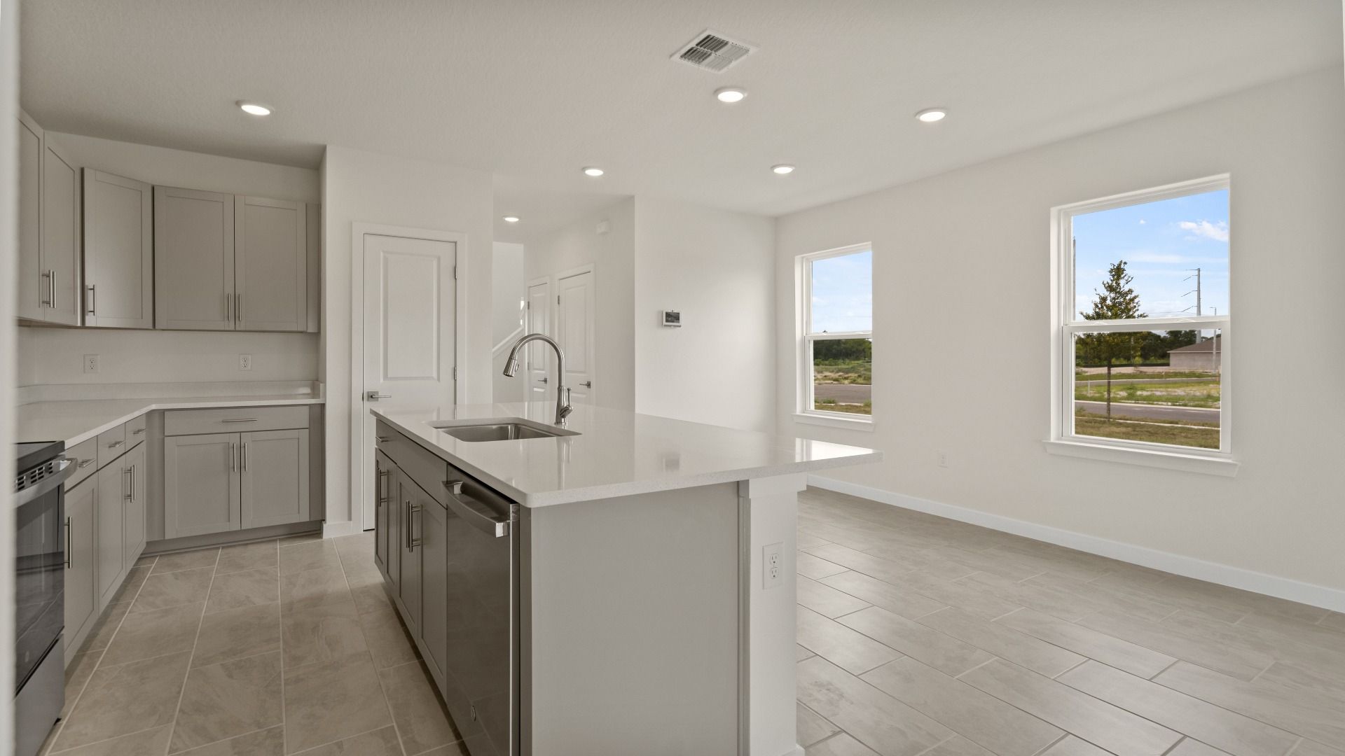 The Naples Kitchen with large Island Quick Move-In Home at Willowbrook North by DRB Homes in Winter Haven, FL