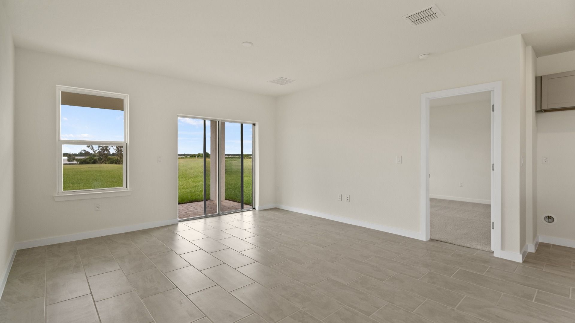 The Naples Kitchen with large Island Quick Move-In Home at Willowbrook North by DRB Homes in Winter Haven, FL