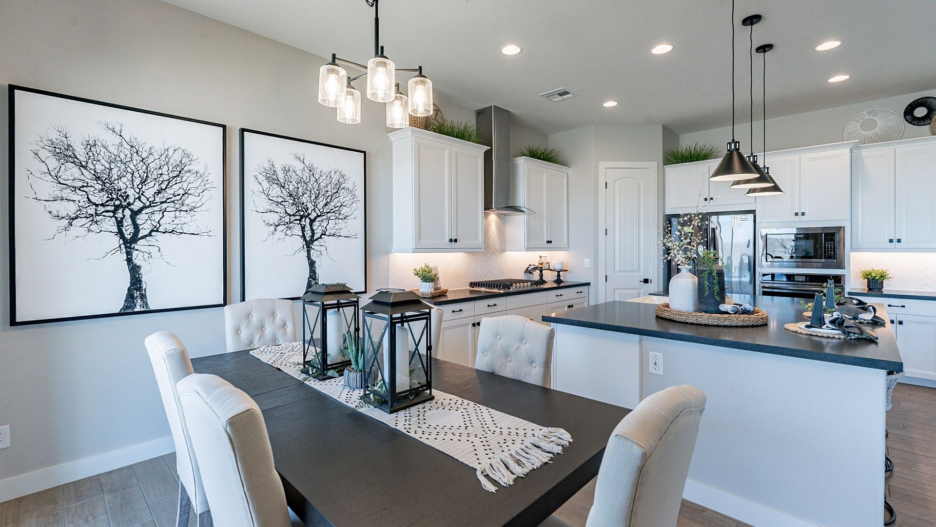 Elegant black countertops and sleek pendant lights enhance this Arroyo Seco Hacienda kitchen.