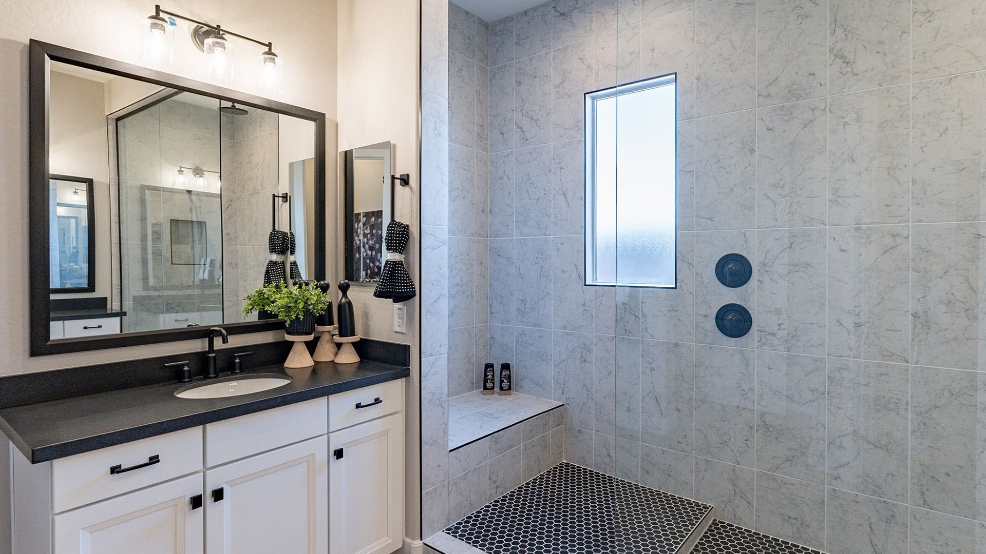 Exquisite glass shower with marble tiles and a sleek black countertop in Arroyo Seco Hacienda.