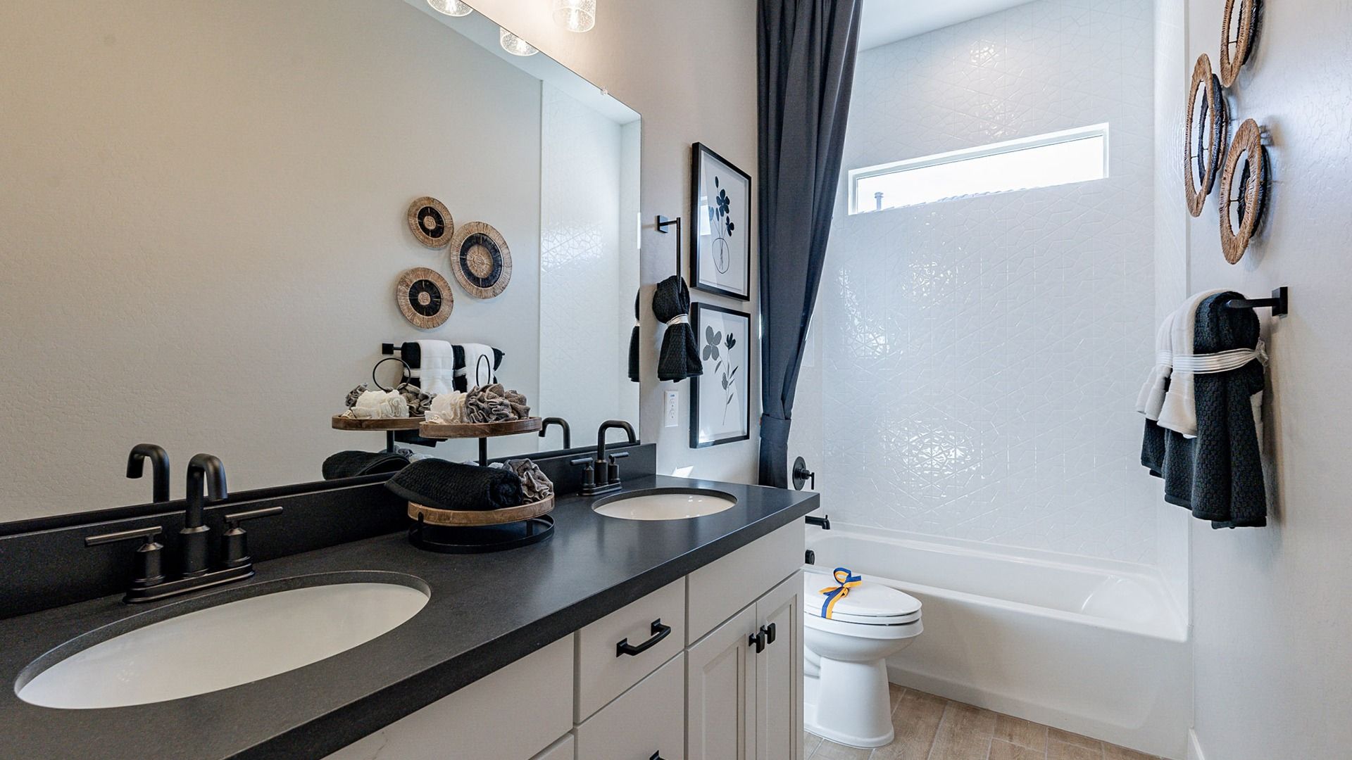 Luxurious dual vanity with black hardware in Arroyo Seco's exquisite Hacienda community.
