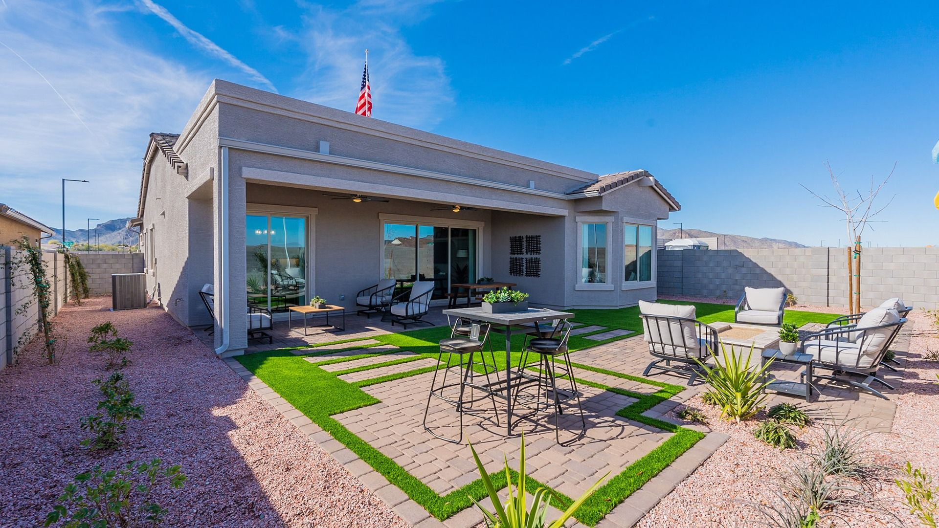 Luxurious outdoor living features chic seating, artificial turf, and elegant pavers in Arroyo Seco.