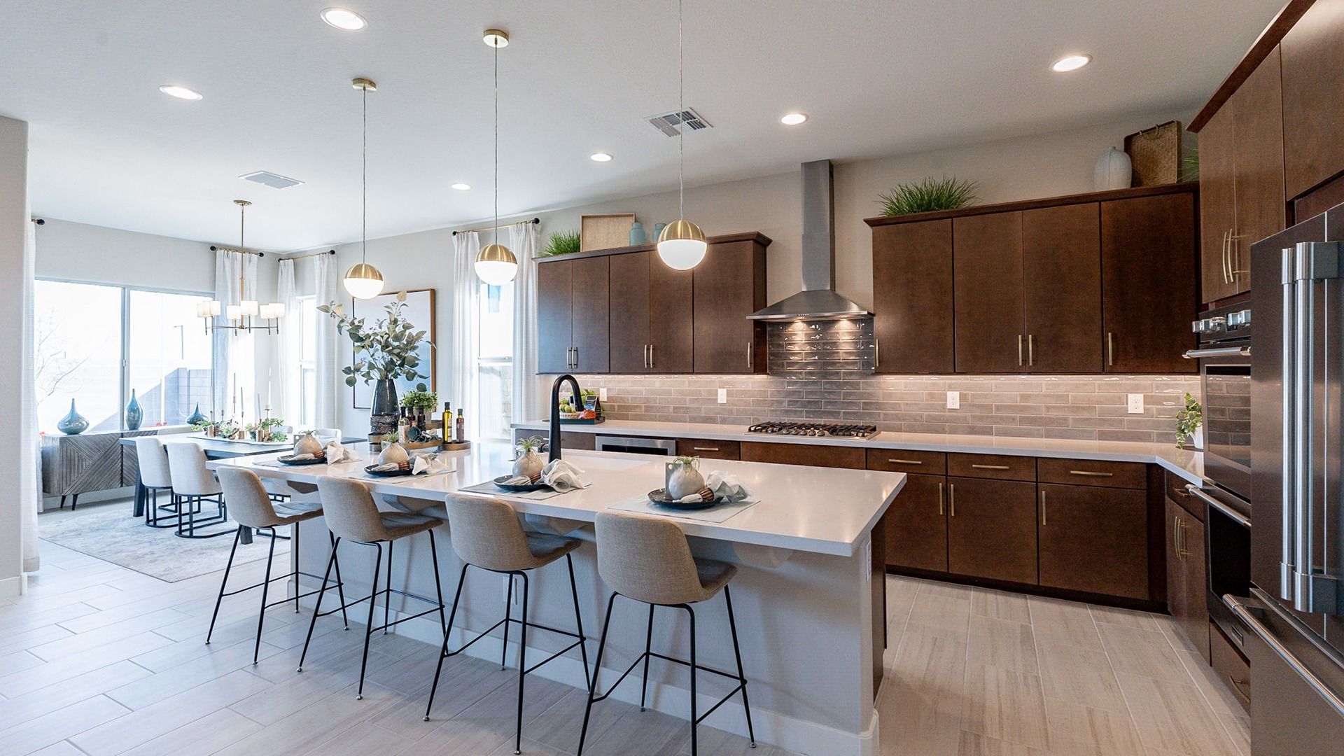 Exquisite kitchen in Arroyo Seco boasts a spacious island, dark wood cabinets, and elegant pendant lighting.