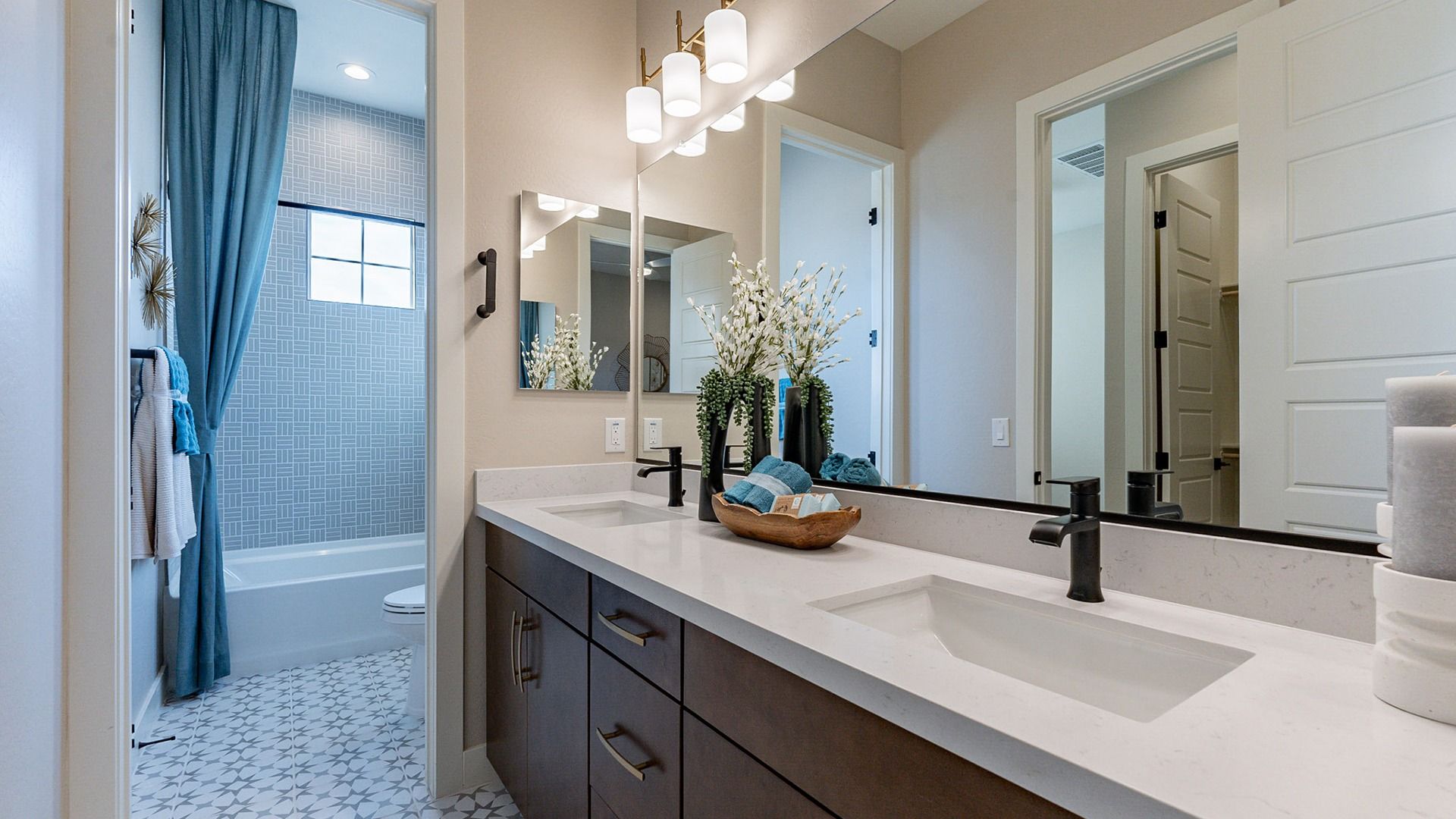 Stunning dual-sink vanity with chic lighting and geometric tiles, reflecting Arroyo Seco luxury.