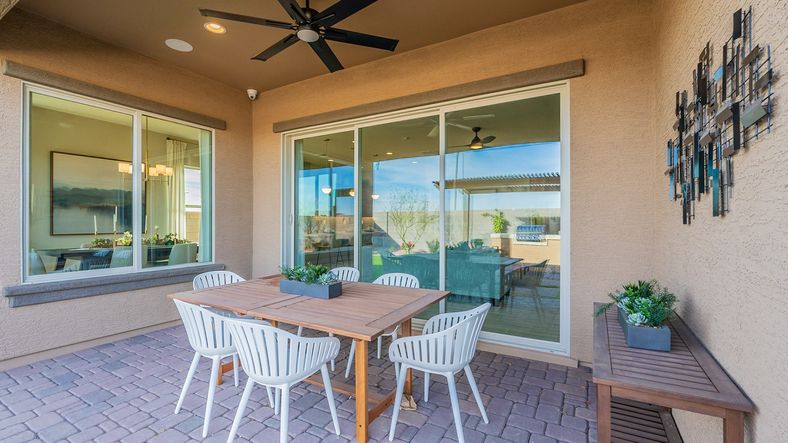 Elegant patio features stylish ceiling fan, sleek sliding doors in Arroyo Seco’s exclusive Hacienda community.