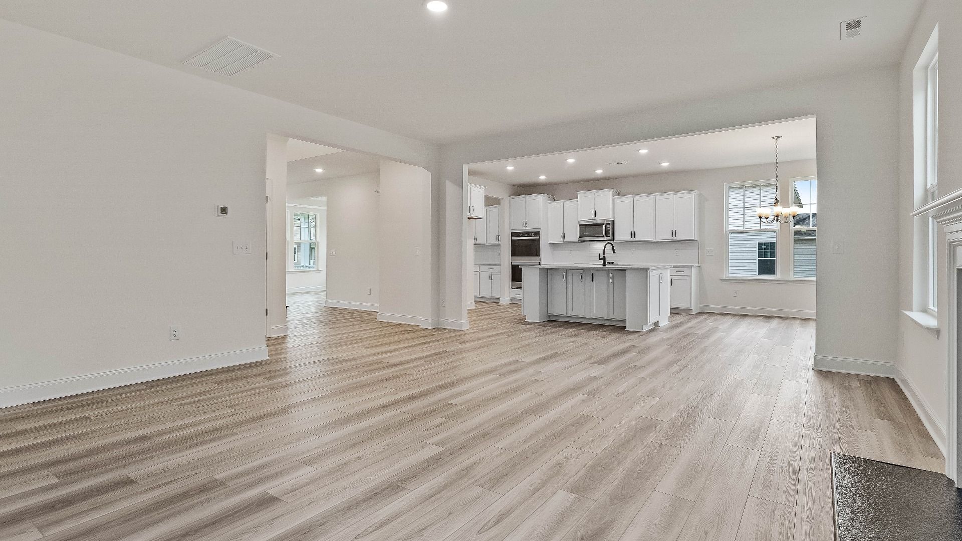 Stonehaven home plan open concept family room/living space with fireplace connecting to kitchen and breakfast area