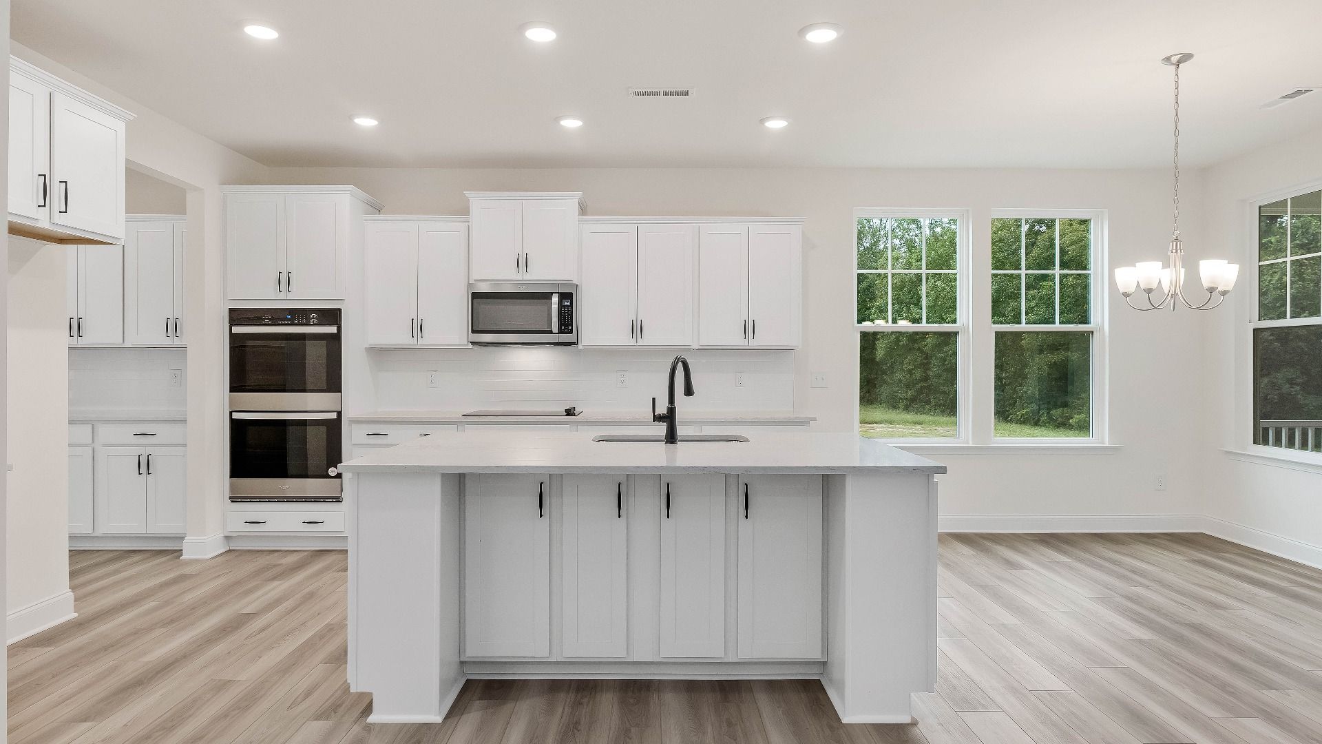 Stonehaven home plan kitchen with large island, ample cabinetry and butler's pantry with adjoining breakfast area
