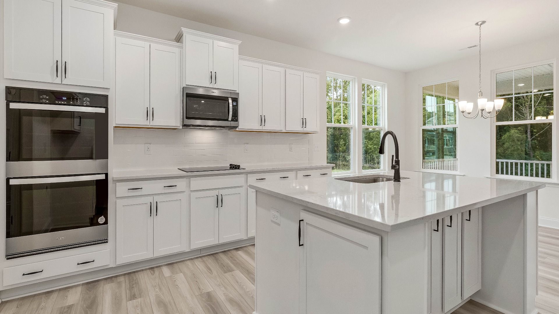 Stonehaven home plan kitchen with large island, ample cabinetry and butler's pantry with adjoining breakfast area