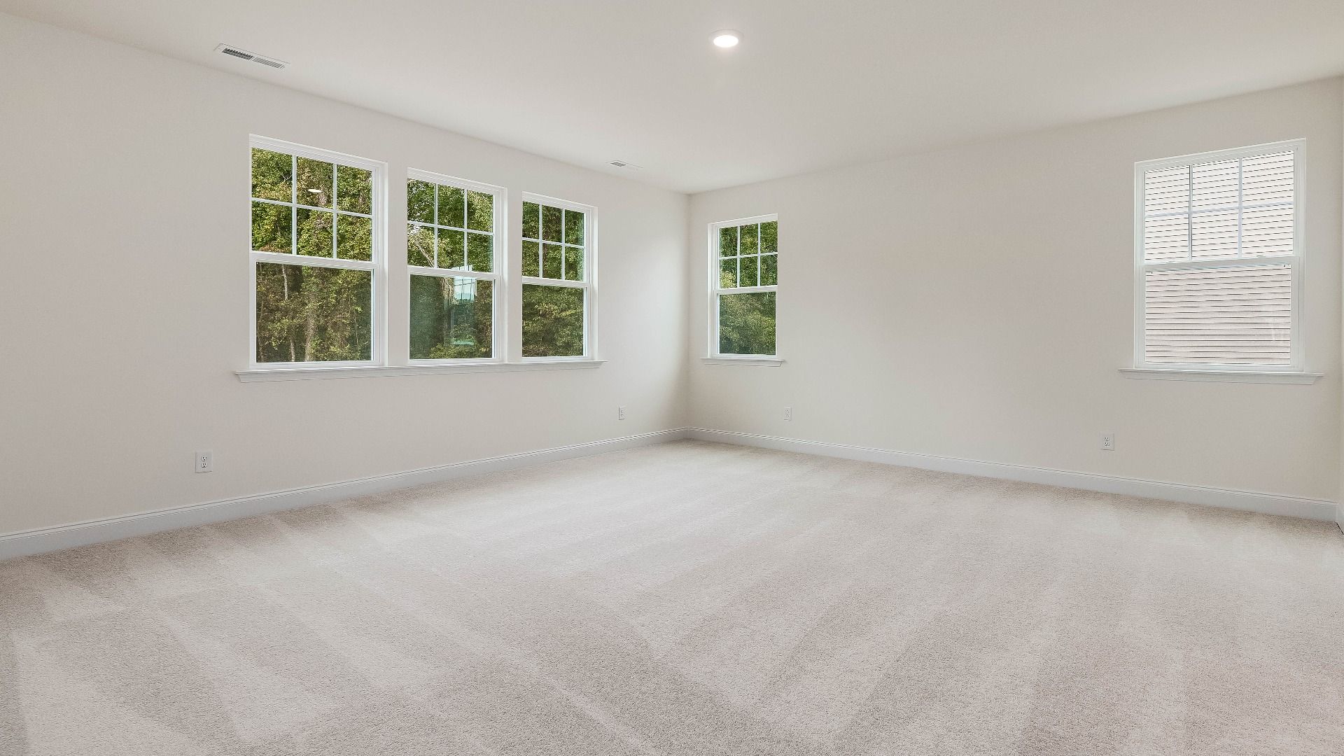 Stonehaven home plan primary bedroom/suite with lots of windows, walk-in closet and en suite bathroom