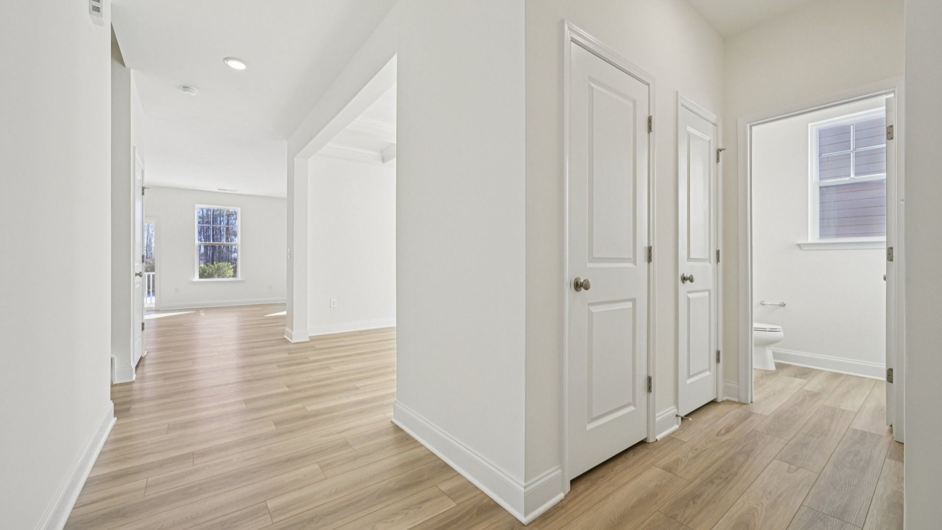 Wagener home plan front entry and powder bath leading into dining room
