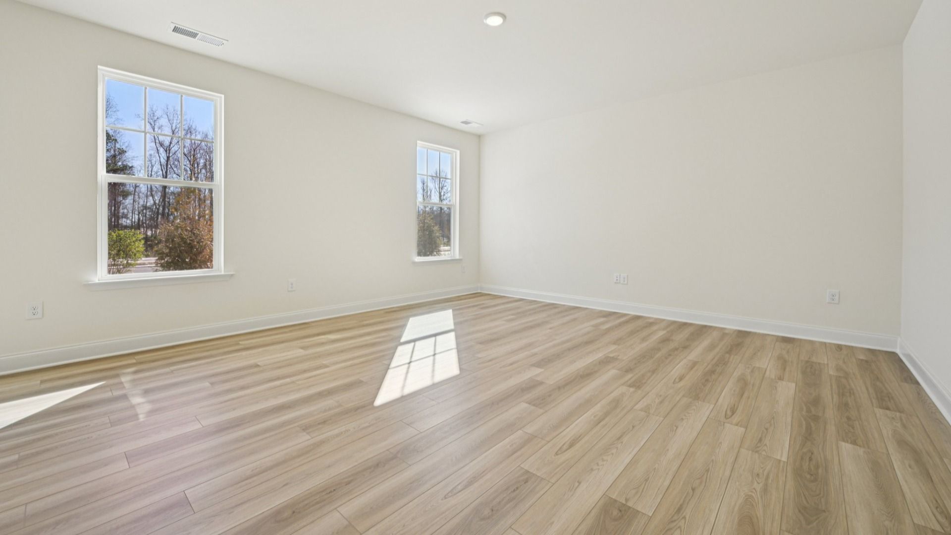 Wagener home plan large living/family room with windows and luxury vinyl plank flooring